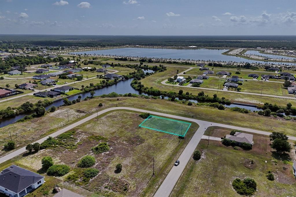An aerial view shows a vacant rectangular lot outlined in green within a residential neighborhood — 3801 NW 41ST STREET, CAPE CORAL, FL
