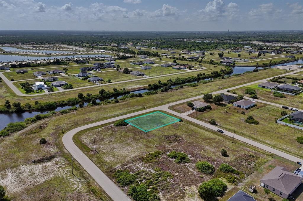 An aerial view shows a vacant residential lot outlined in green within a suburban neighborhood — 3801 NW 41ST STREET, CAPE CORAL, FL