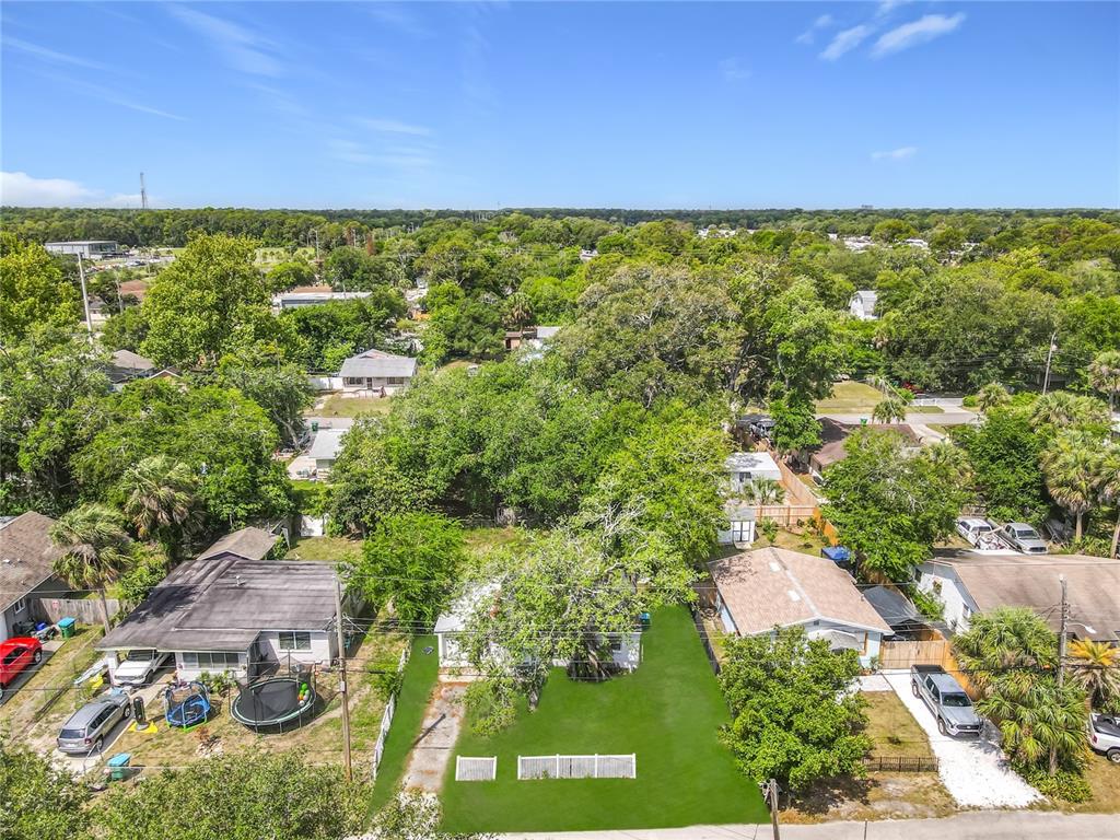 An aerial view shows a single-story house with a large green lawn and mature trees — 1312 JARECKI AVENUE, HOLLY HILL, FL
