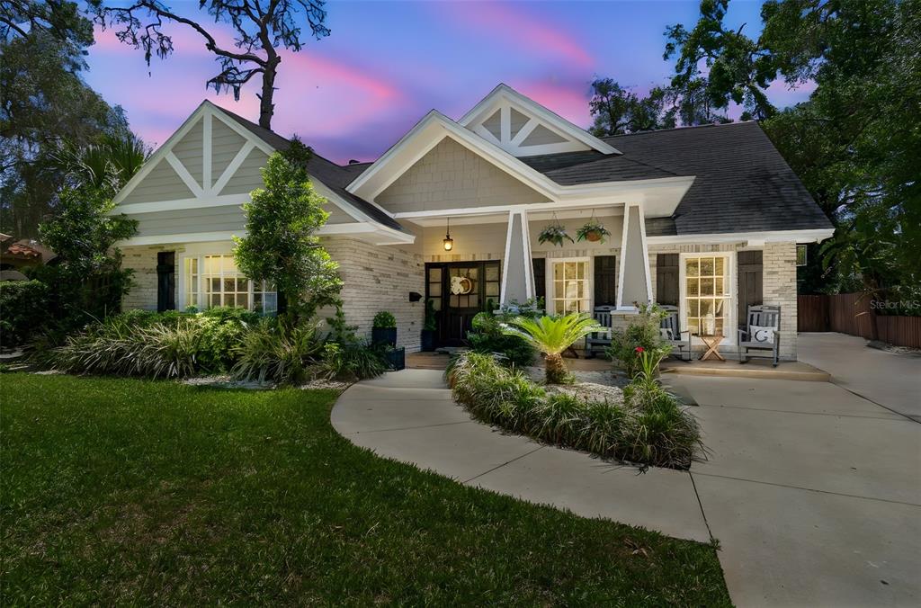 A single-story house with a brick and siding exterior, a front porch, and a driveway — 4528 W WOODMERE ROAD, TAMPA, FL