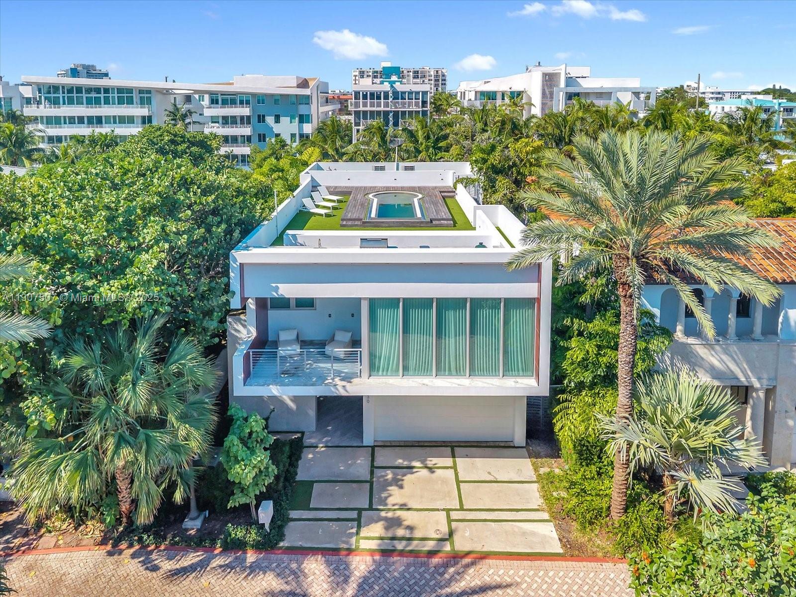 An aerial view of a modern two-story house with a rooftop pool and deck — 7830 Atlantic Way, Miami Beach FL 33141, MIAMI BEACH, FL