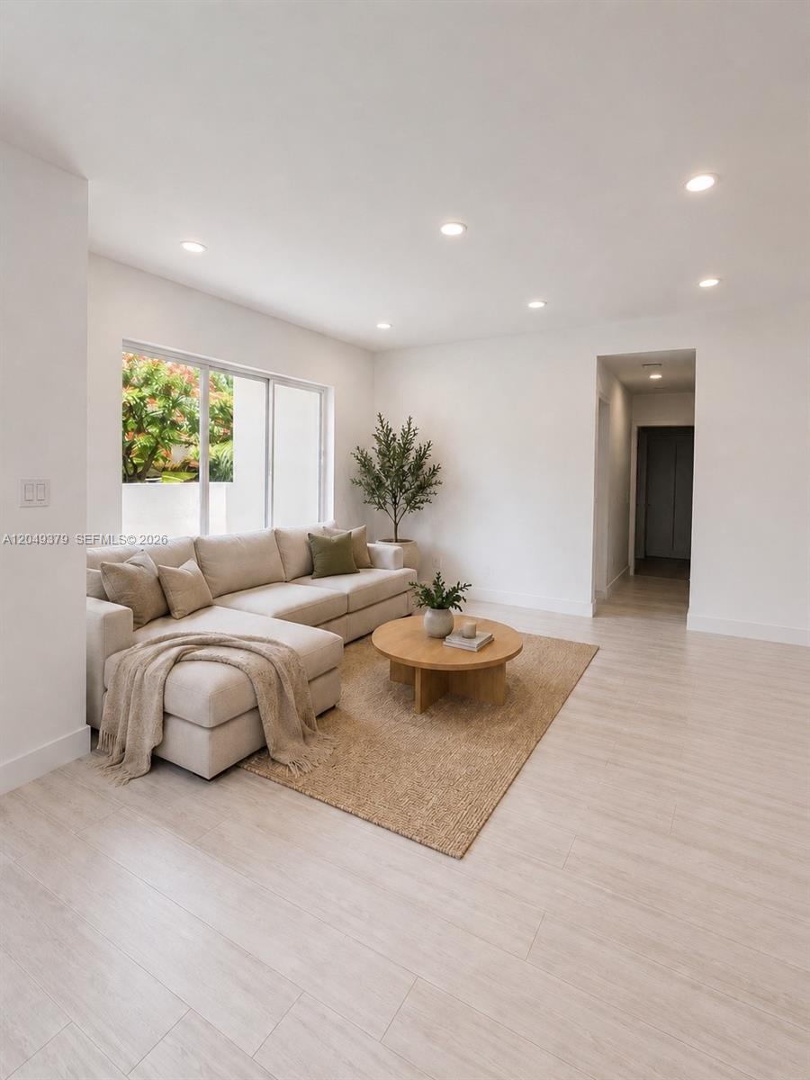 A living room features a beige sectional sofa, a round wooden coffee table, and light-colored flooring — 11011 SW 162nd Ter, Miami FL 33157, MIAMI, FL