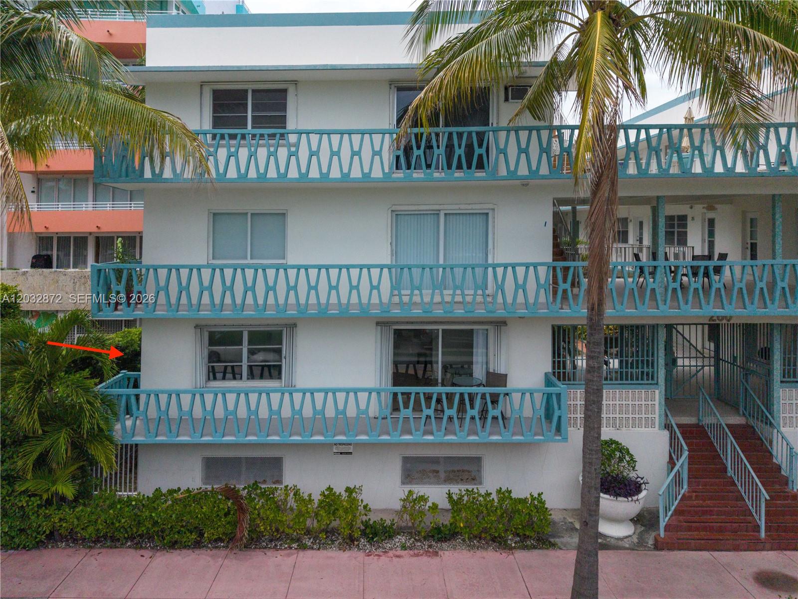 A three-story white apartment building features blue geometric railings on each balcony — 260 Ocean Dr # 12A, Miami Beach FL 33139, MIAMI BEACH, FL