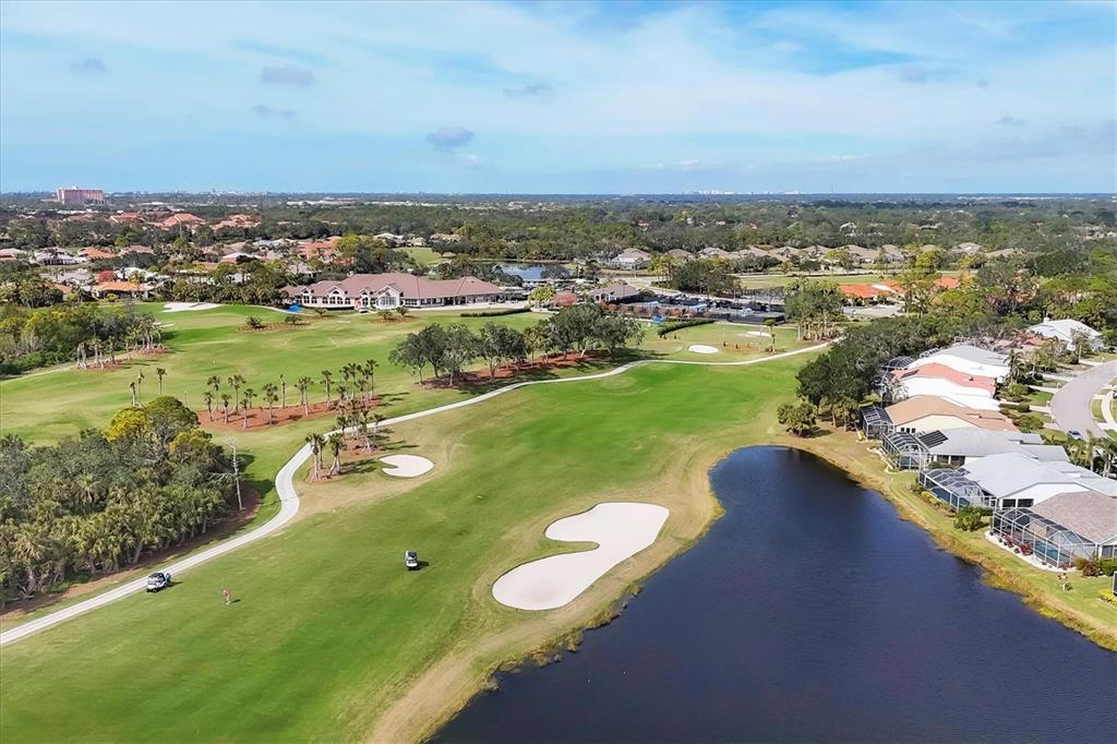 An aerial view of a golf course fairway with a sand bunker and a pond — 9610 CLUB SOUTH CIRCLE UNIT 4106, SARASOTA, FL