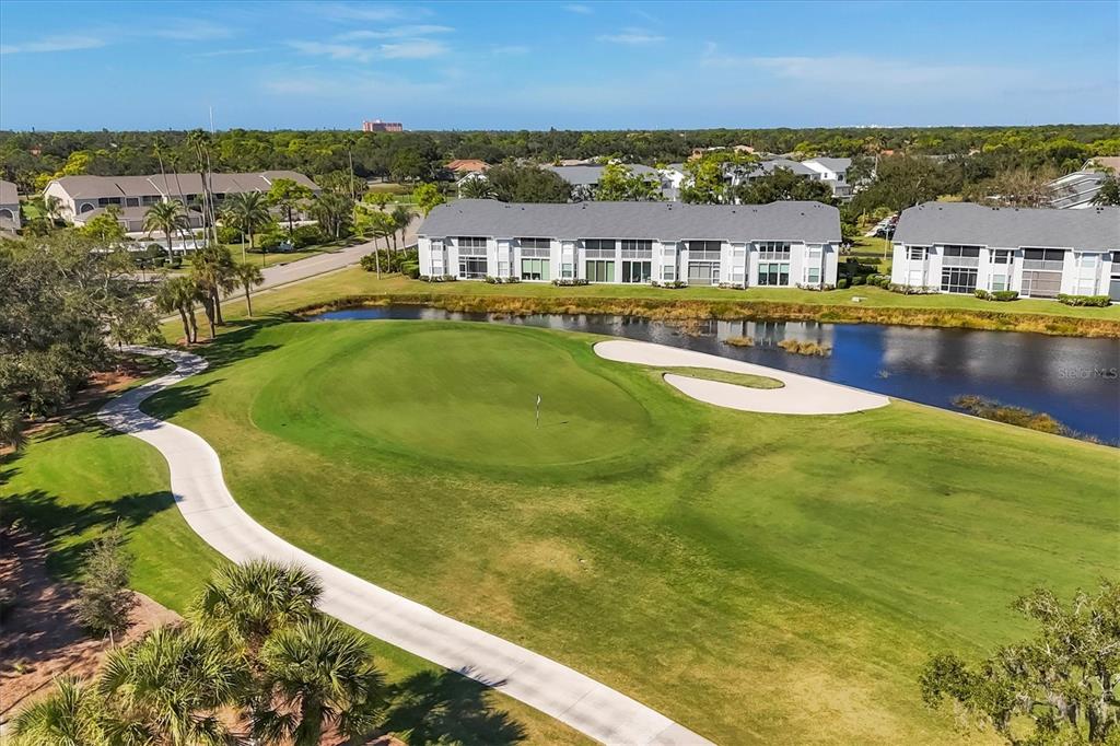 An aerial view shows a golf course green, a sand bunker, and a pond — 9610 CLUB SOUTH CIRCLE UNIT 4106, SARASOTA, FL