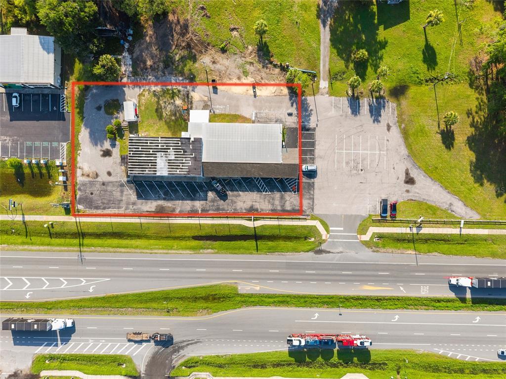 An aerial view shows a commercial building with a parking lot next to a highway — 17313 NE US HWY 301, WALDO, FL