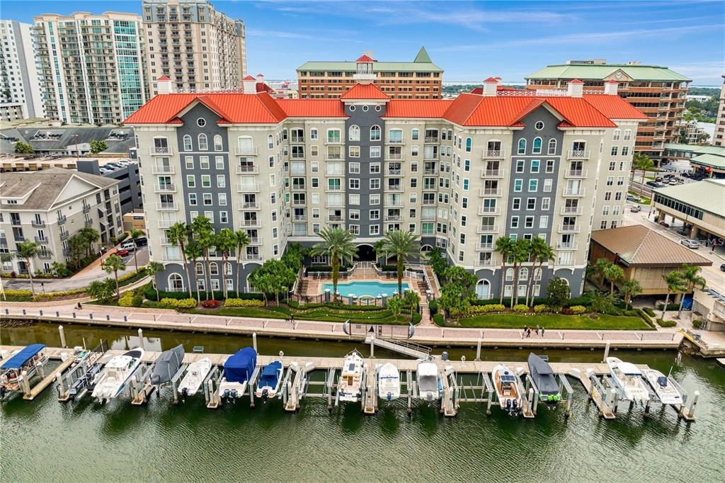 A hallway in an apartment building features a brown door labeled 137 and carpeted flooring — 700 S HARBOUR ISLAND BOULEVARD UNIT 137, TAMPA, FL