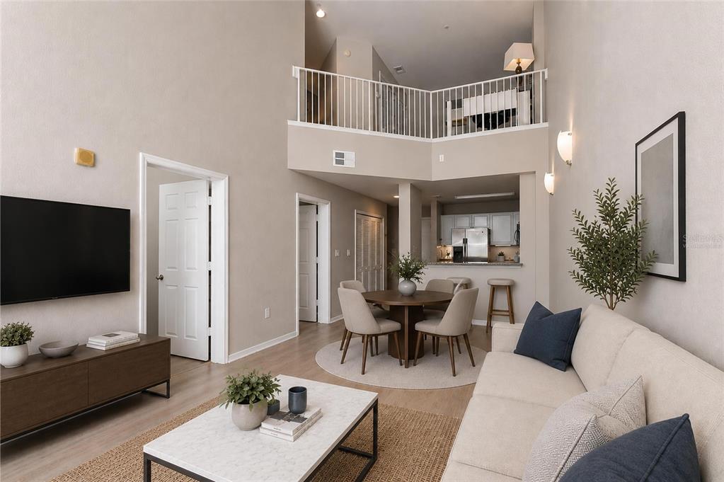 A bright living and dining area with high ceilings, light wood floors, and neutral furniture — 700 S HARBOUR ISLAND BOULEVARD UNIT 137, TAMPA, FL