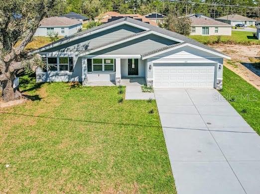 A single-story suburban house with a gray exterior, a two-car garage, and a concrete driveway — 102 SAIL WAY, KISSIMMEE, FL