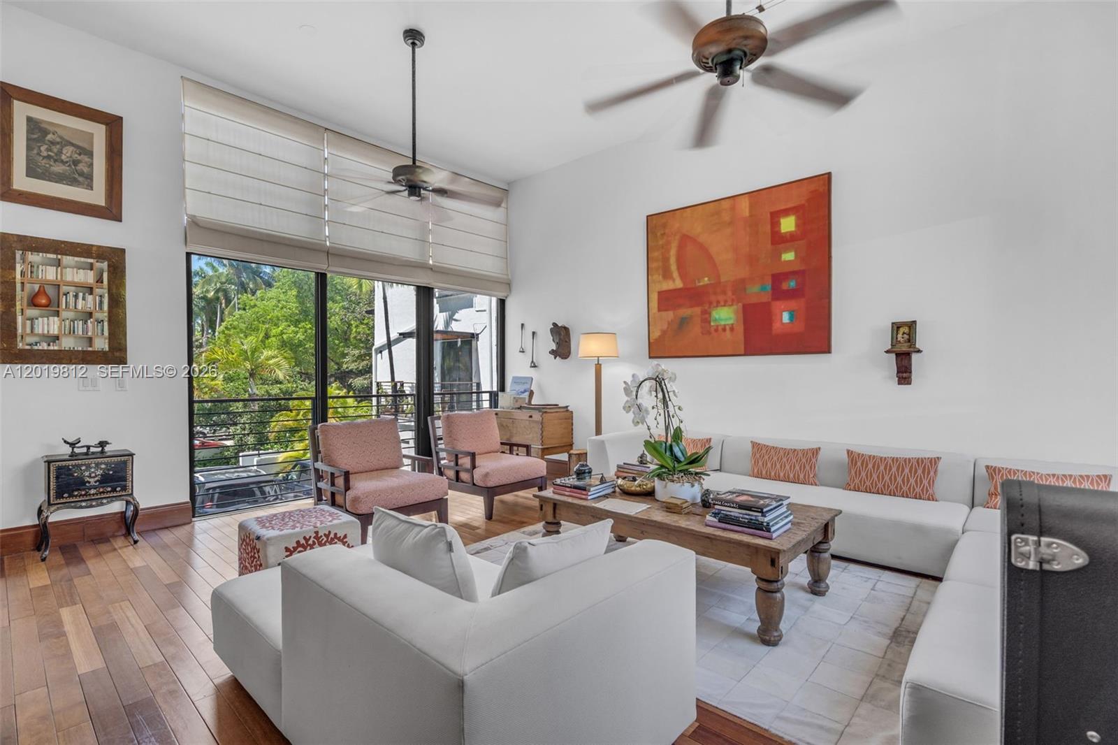 A bright living room features a white sectional sofa, wooden coffee table, and large windows — 209 E Enid Dr # 36, Key Biscayne FL 33149, KEY BISCAYNE, FL
