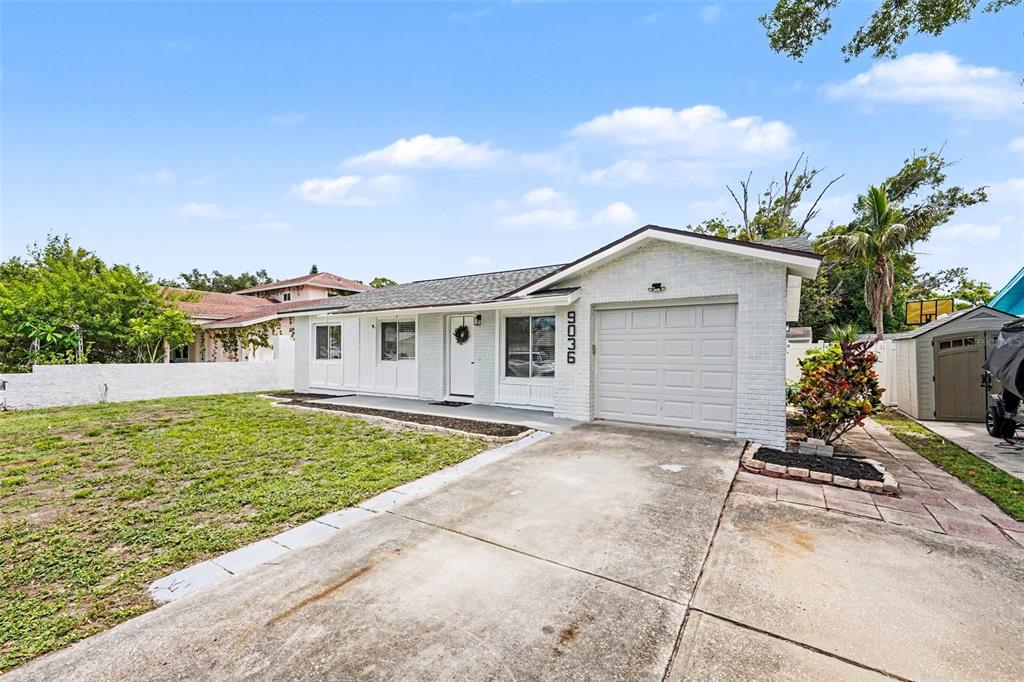 A living room features a sofa, a wooden coffee table, and a television on a console — 9036 109TH TERRACE, SEMINOLE, FL