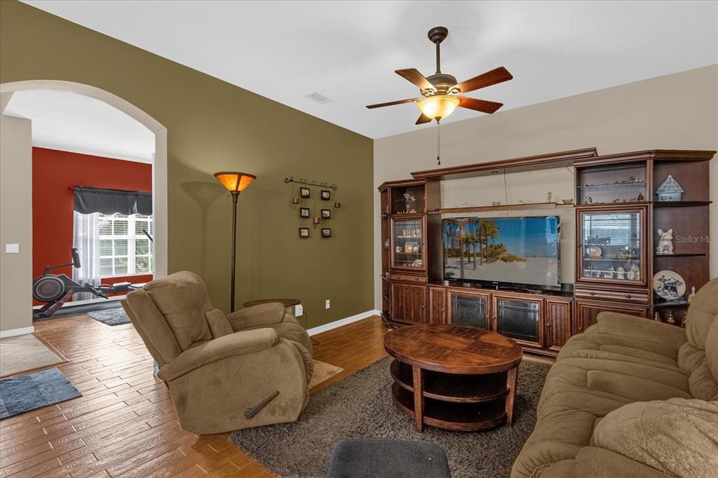 A living room features a large entertainment center, a brown recliner, and a sofa — 1355 ALSTON BAY BOULEVARD, APOPKA, FL