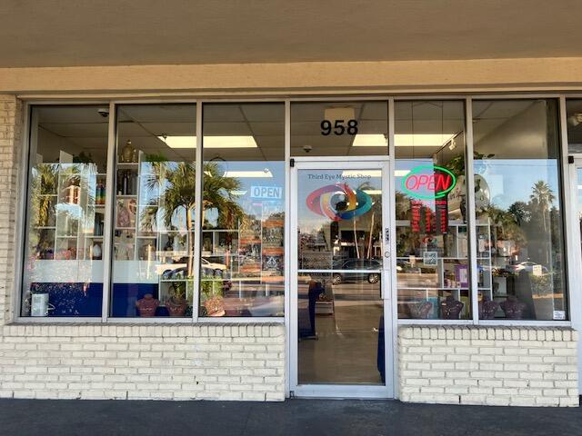 The exterior of a retail storefront features a brick facade, large glass windows, and a glass door — 958 Northlake Boulevard, Lake Park FL 33403, LAKE PARK, FL
