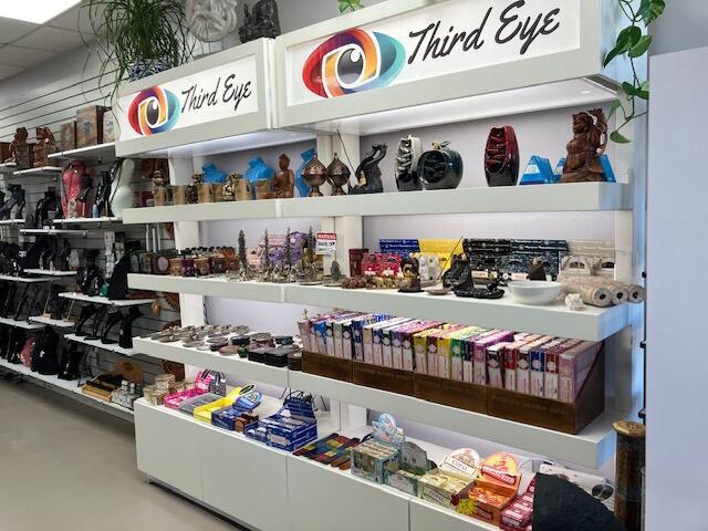 Shelves in a retail store display various spiritual items, incense, and decorative figurines — 958 Northlake Boulevard, Lake Park FL 33403, LAKE PARK, FL