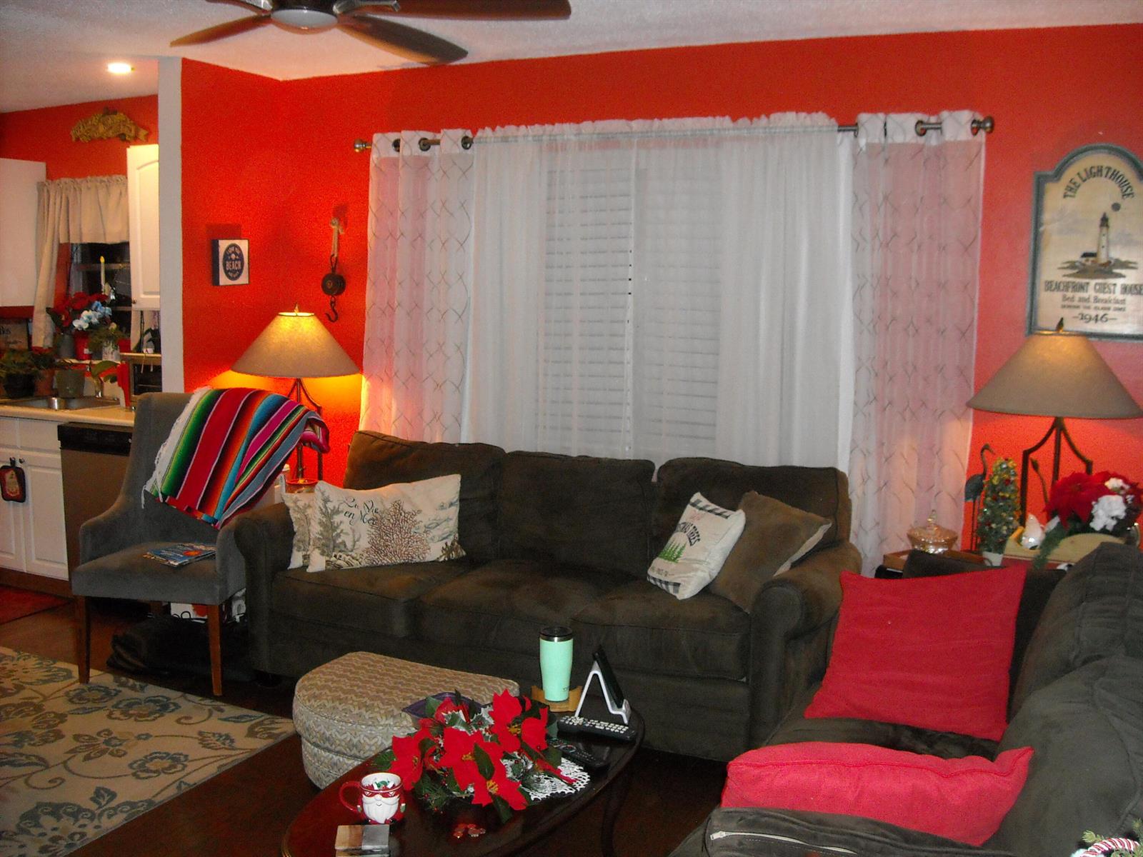 A living room features a dark sofa, red walls, a ceiling fan, and white curtains — 216 Sheffield I, West Palm Beach FL 33417, WEST PALM BEACH, FL