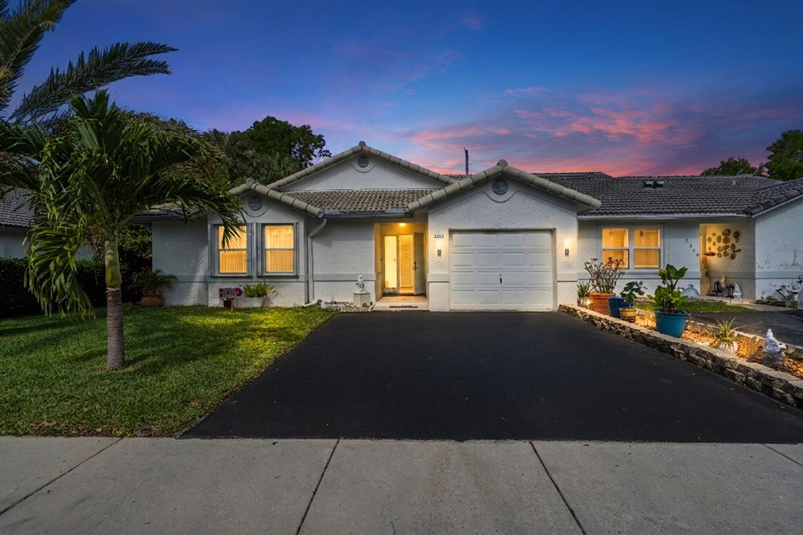 A single-story house with a white stucco exterior, a tile roof, and a paved driveway — 3343 NW 79th Way, Davie FL 33024, DAVIE, FL