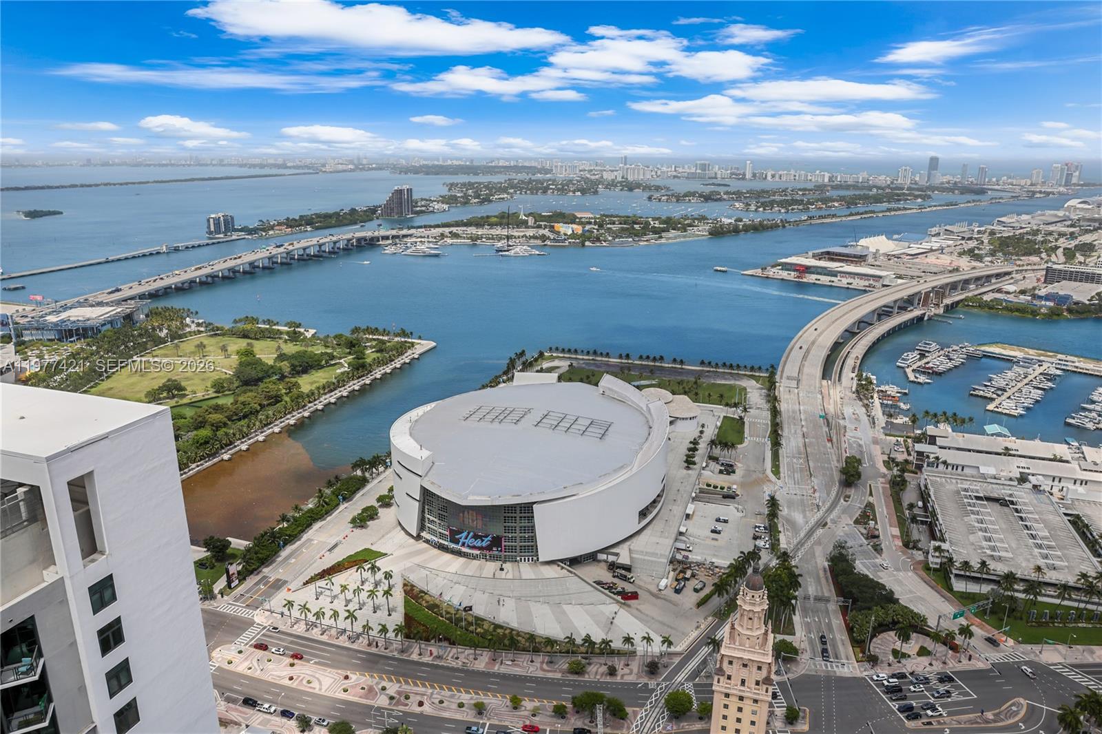 An aerial view shows the Kaseya Center arena, surrounding roads, and Biscayne Bay in Miami — 159 NE 6th St # 5115, Miami FL 33132, MIAMI, FL