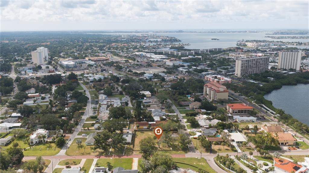 An aerial view shows a vacant, tree-covered lot marked with a house icon in a neighborhood — 698 VILLAGRANDE AVENUE S, ST PETERSBURG, FL