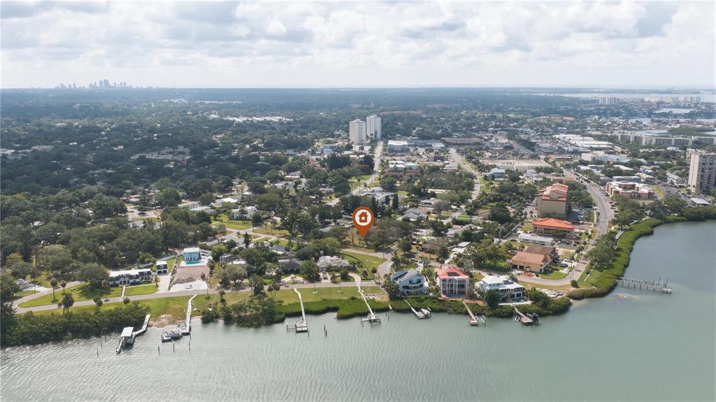 An aerial view shows a waterfront neighborhood with a highlighted property lot — 698 VILLAGRANDE AVENUE S, ST PETERSBURG, FL