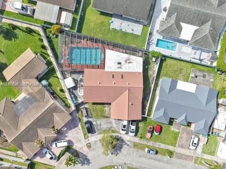 An aerial view shows a residential house with a pool and a screened-in patio — 13216 SW 45th Ln, Miami FL 33175, MIAMI, FL