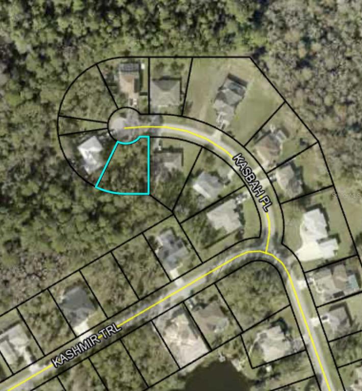 This is an aerial map showing a residential lot highlighted in blue on a cul-de-sac — 15 KASBAH PLACE, PALM COAST, FL