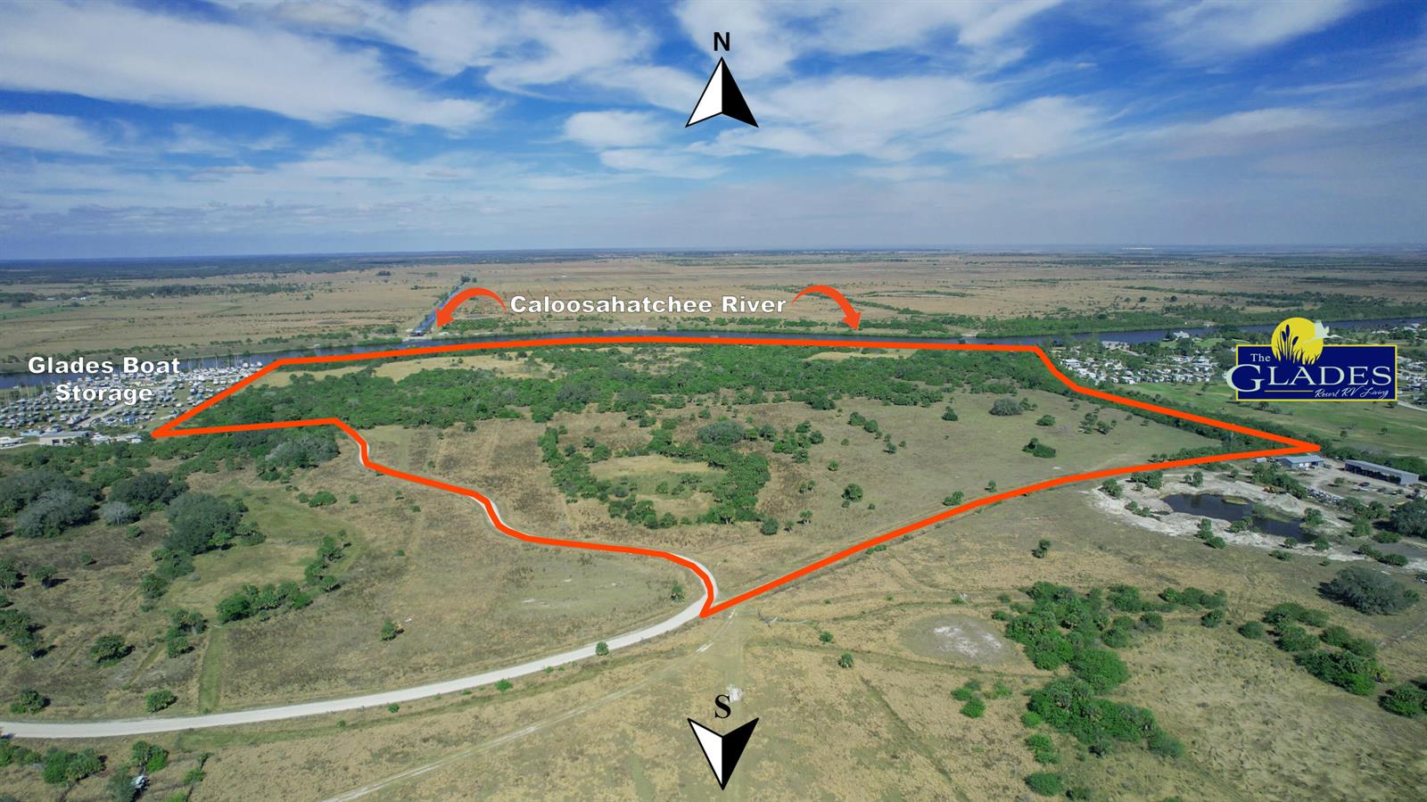 An aerial view shows a large, undeveloped parcel of land outlined in red near a river — 000 Andreachi Road, Moore Haven FL 33471, MOORE HAVEN, FL