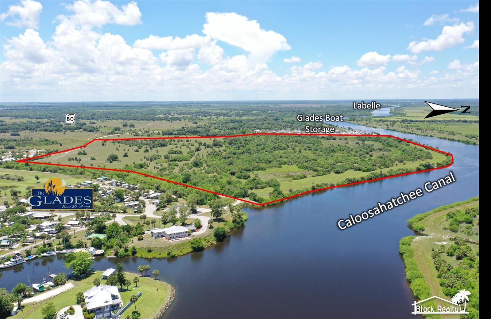 An aerial view shows a large, undeveloped parcel of land bordering the Caloosahatchee Canal — 000 Andreachi Road, Moore Haven FL 33471, MOORE HAVEN, FL