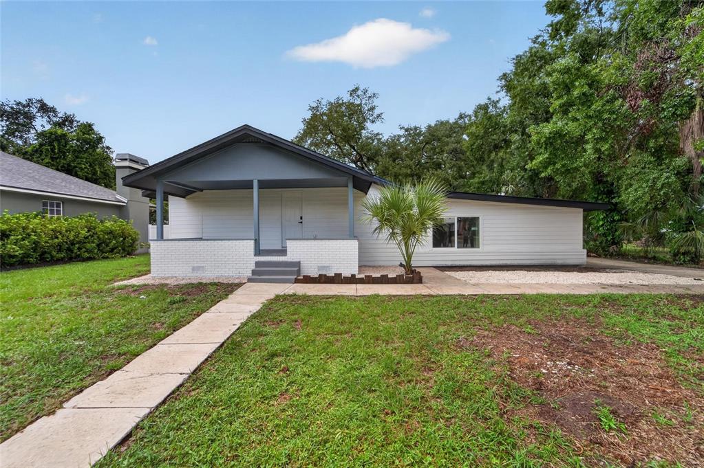A single-story house with white siding, a covered front porch, and a brick base — 8809 DYER ROAD, RIVERVIEW, FL