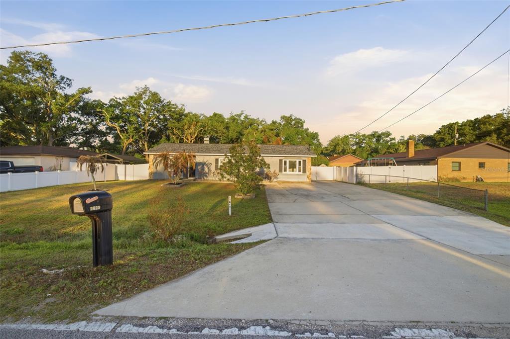 A single-story house with a concrete driveway, a front lawn, and a black mailbox — 7403 PROVIDENCE ROAD, RIVERVIEW, FL