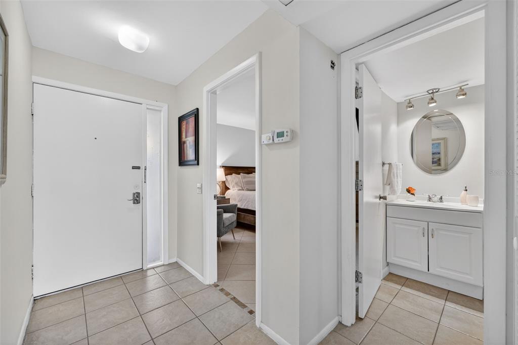 A tiled entryway leads to a bedroom doorway on the left and a bathroom door — 3061 QUAIL HOLLOW UNIT # 35, SARASOTA, FL