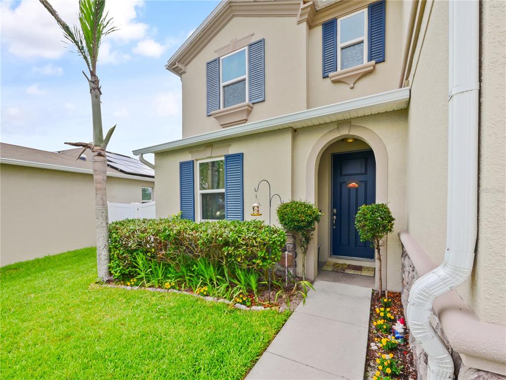 A two-story house exterior features a blue front door, blue shutters, and a palm tree — 4597 BALER TRAILS DRIVE, ST CLOUD, FL