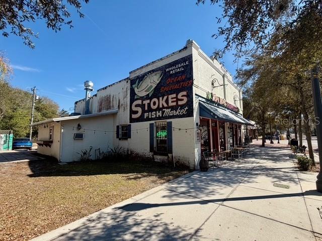 A historic brick building with a large painted sign for Stokes Fish Market — 417 & 419 SANFORD AVENUE, SANFORD, FL