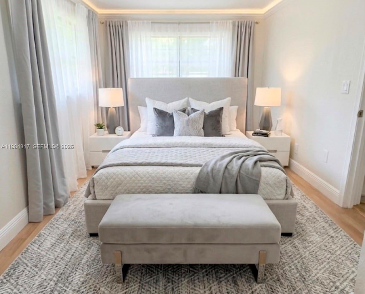 A modern bedroom features a gray upholstered bed, matching bench, nightstands, and floor-to-ceiling curtains — 8866 SW 126th St, Miami FL 33176, MIAMI, FL