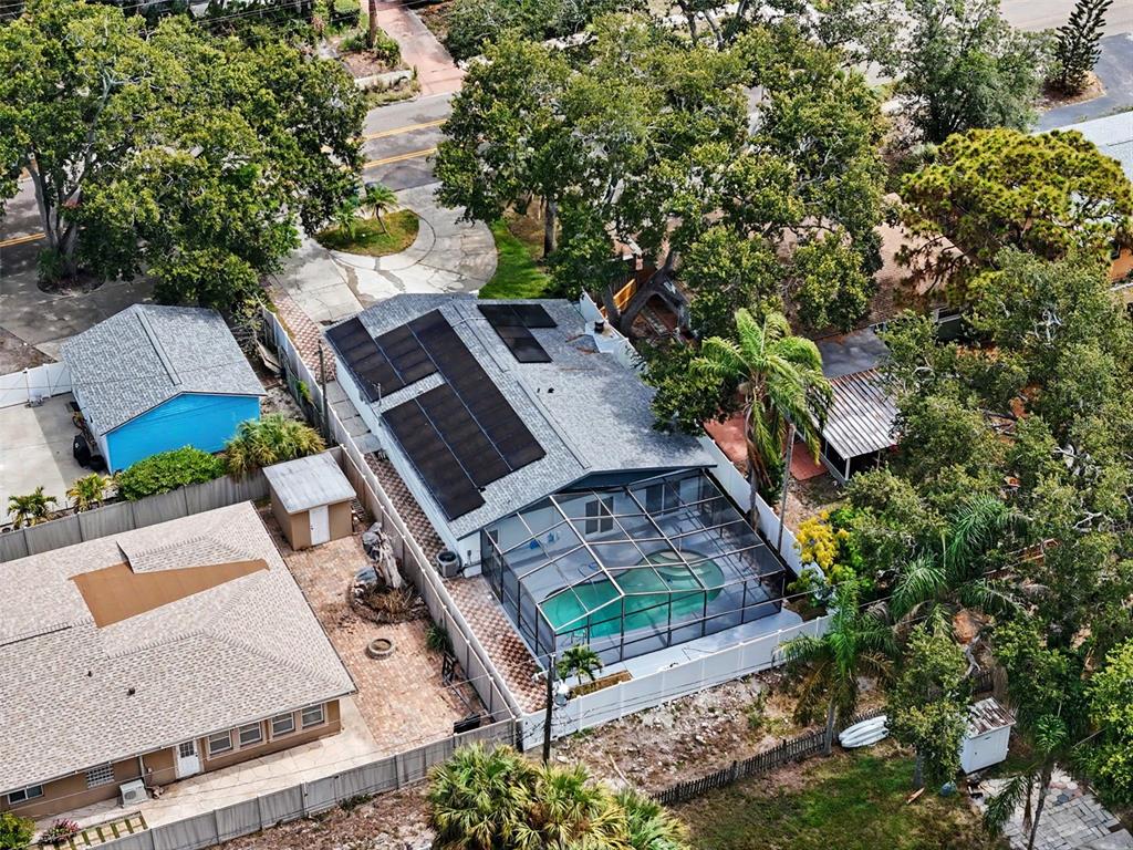 An aerial view of a house with solar panels and a screened-in swimming pool — 8170 22ND AVENUE N, ST PETERSBURG, FL