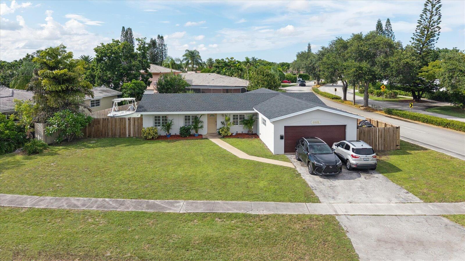 A single-story house with a dark roof, white exterior, and a two-car garage — 4601 W Hawthorne Circle, Hollywood FL 33021, HOLLYWOOD, FL