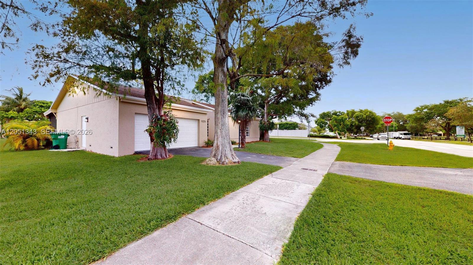 A single-story house with a two-car garage, a concrete driveway, and a sidewalk — 10251 SW 80th St # 0, Miami FL 33173, MIAMI, FL