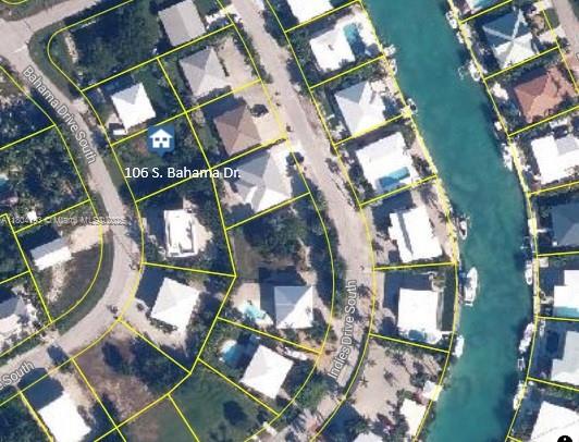 This is an aerial map view of a residential neighborhood with houses along a canal — 106 S Bahama Dr, Duck FL 33050, DUCK, FL