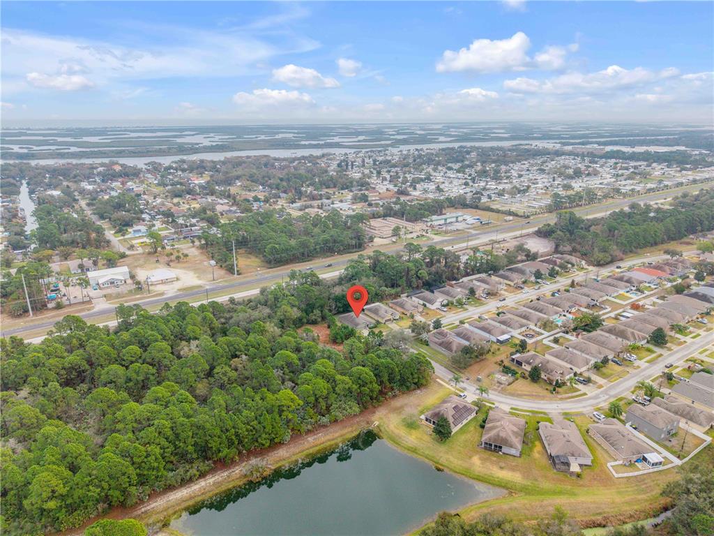 An aerial view shows a suburban neighborhood with a red pin marking a single-family home — 353 ADMIRALTY COURT, EDGEWATER, FL