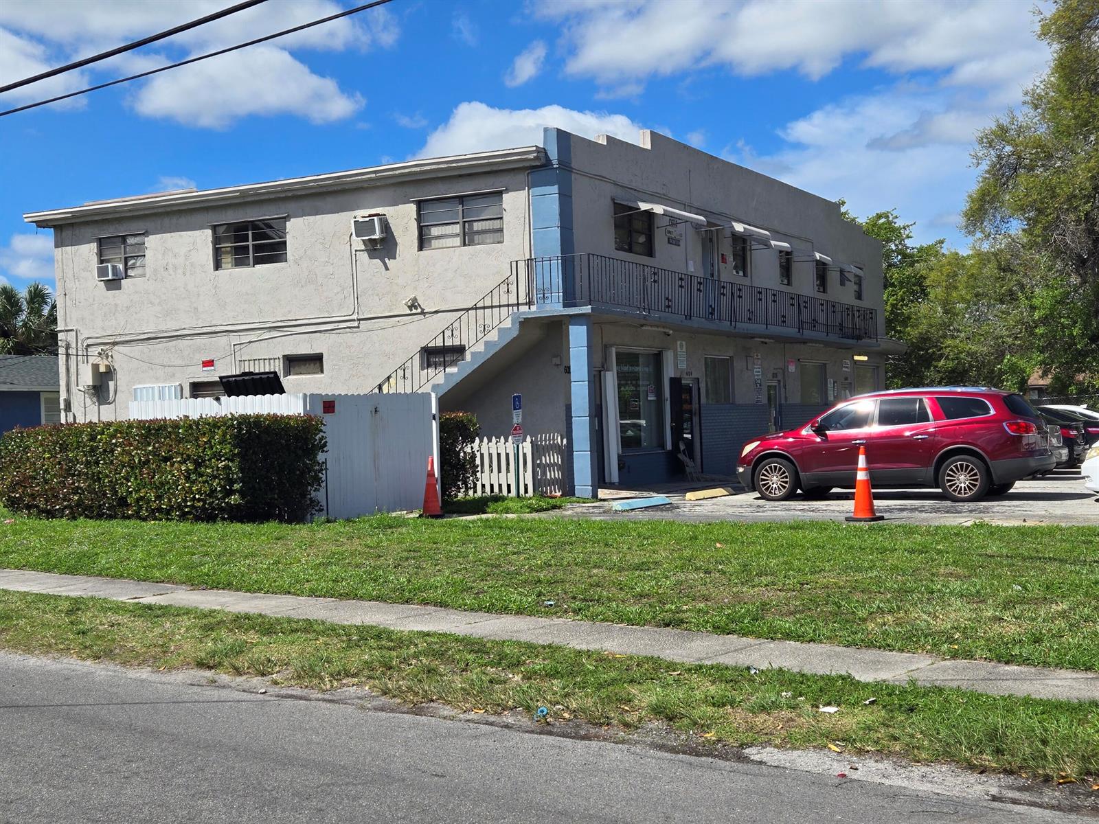 A two-story commercial building with a red SUV parked in front — 602 NW 1st Street, Dania Beach FL 33004, DANIA BEACH, FL