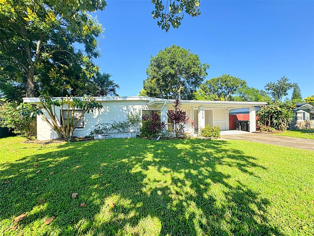 A single-story white brick house with a carport and a large front lawn — 3628 DAGON STREET, ORLANDO, FL