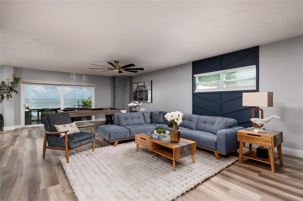 A living room features a blue sectional sofa, a pool table, and a water view — 3319 BAYSHORE BOULEVARD NE, ST PETERSBURG, FL