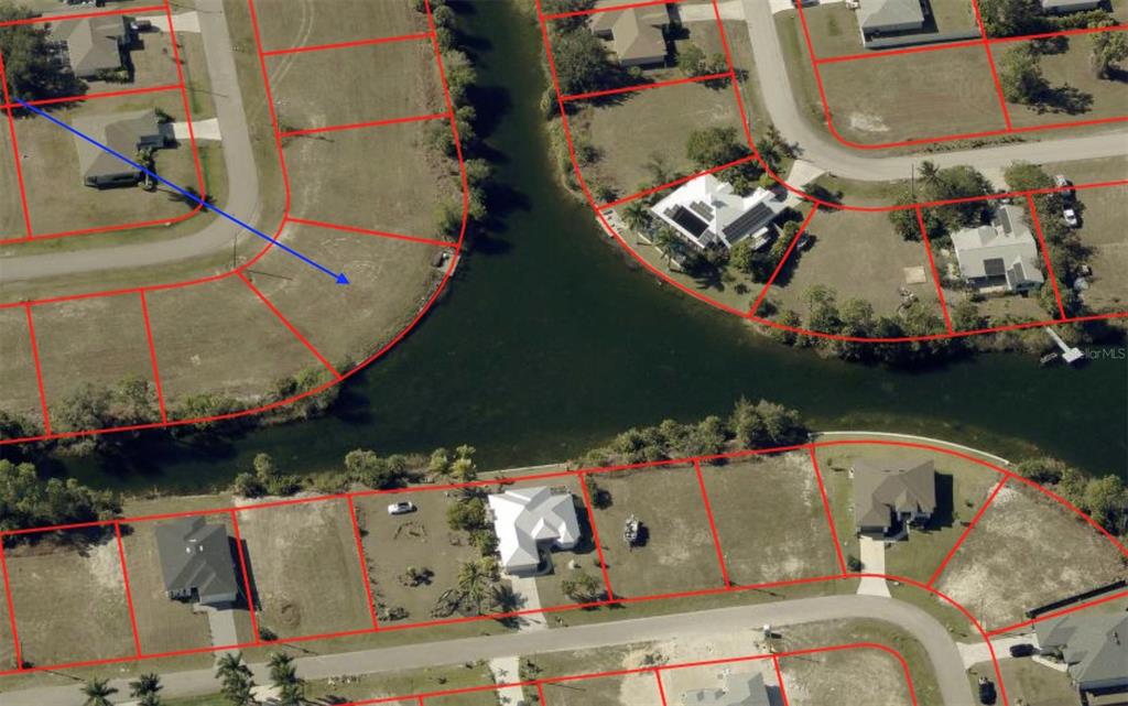 This aerial map shows residential lots and houses situated along a canal — 1133 NE 32ND TERRACE, CAPE CORAL, FL