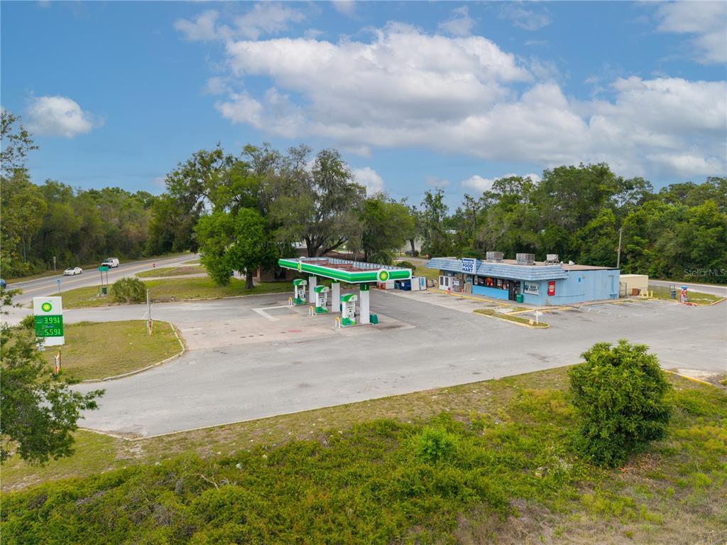 An aerial view shows a BP gas station with a convenience store and fuel pumps — 487 S US 301, SUMTERVILLE, FL