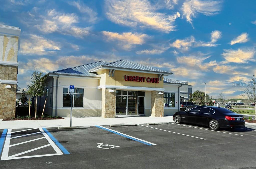 A single-story commercial building with an Urgent Care sign and a parking lot in front — 4669 E SR 44 UNIT 102/103, WILDWOOD, FL