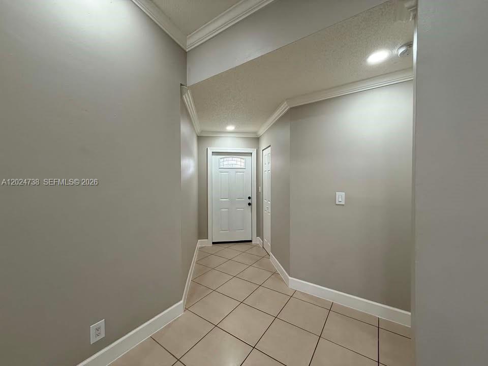 A tiled entryway leads to a white front door in a neutral-toned home interior — 6449 NW 171st St # 0, Hialeah FL 33015, HIALEAH, FL