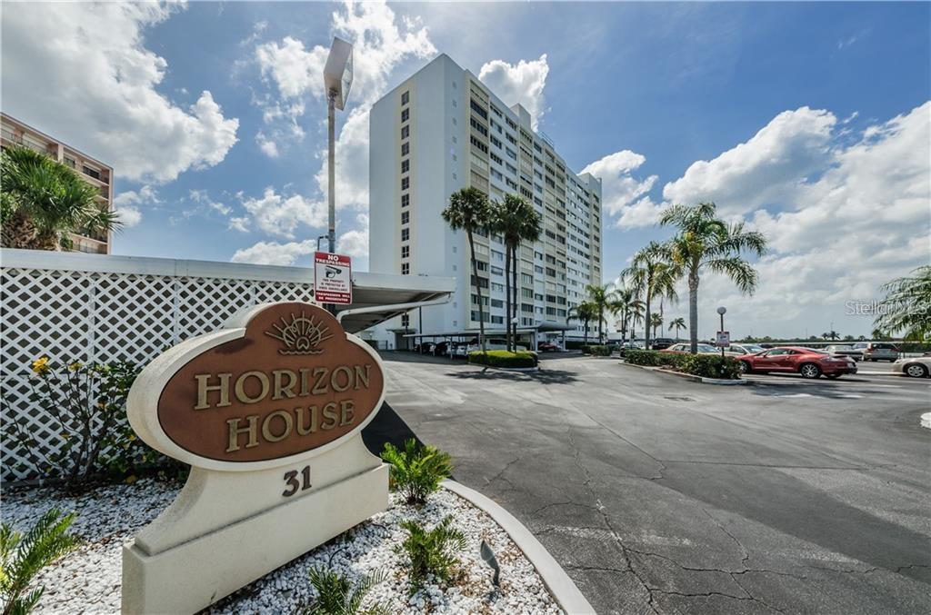 A sign for Horizon House stands in front of a tall residential building and parking lot — 31 ISLAND WAY UNIT 408, CLEARWATER BEACH, FL