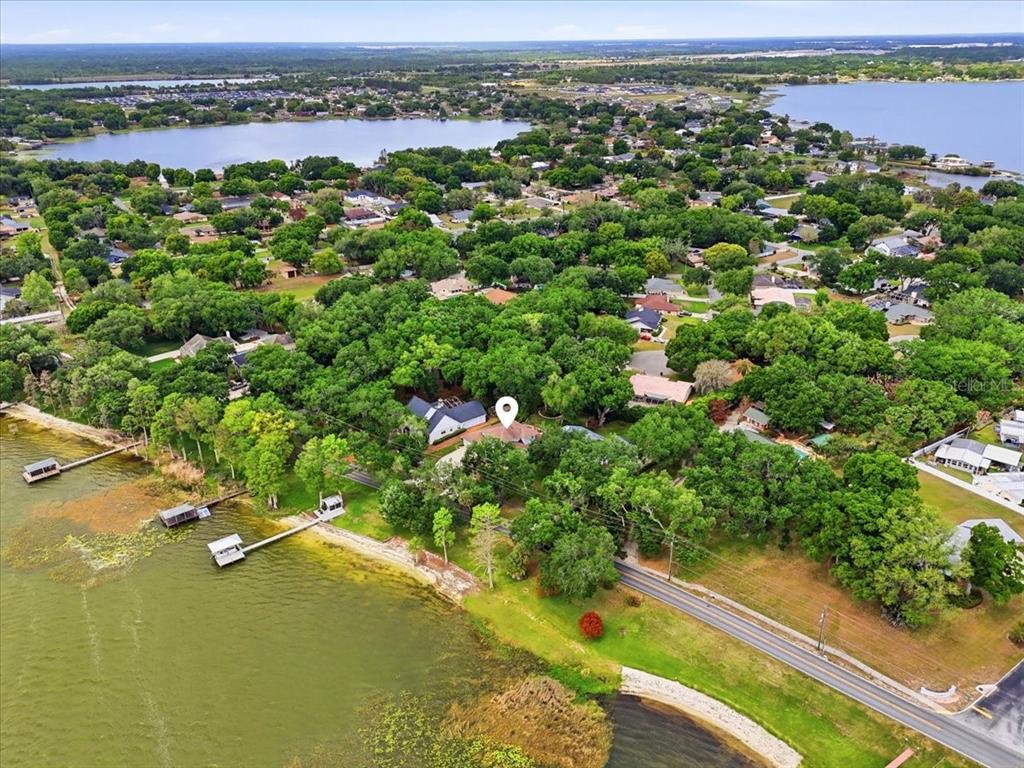 An aerial view shows a house with a white location pin near a lake — 2000 LAKE ARIANA BOULEVARD, AUBURNDALE, FL