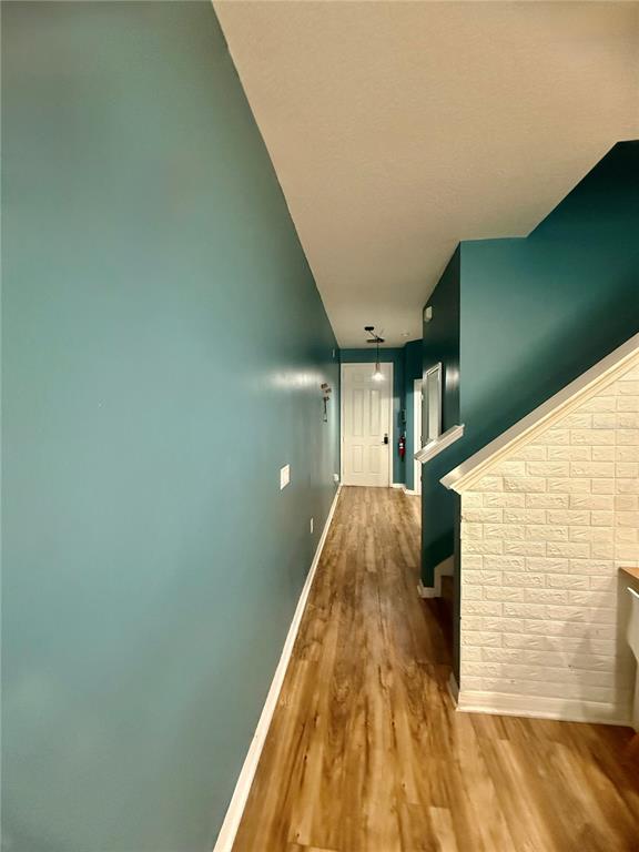 A bedroom features light blue walls, wood-look flooring, and a dark blue bunk bed — 2672 MAYAGUANA STREET, KISSIMMEE, FL