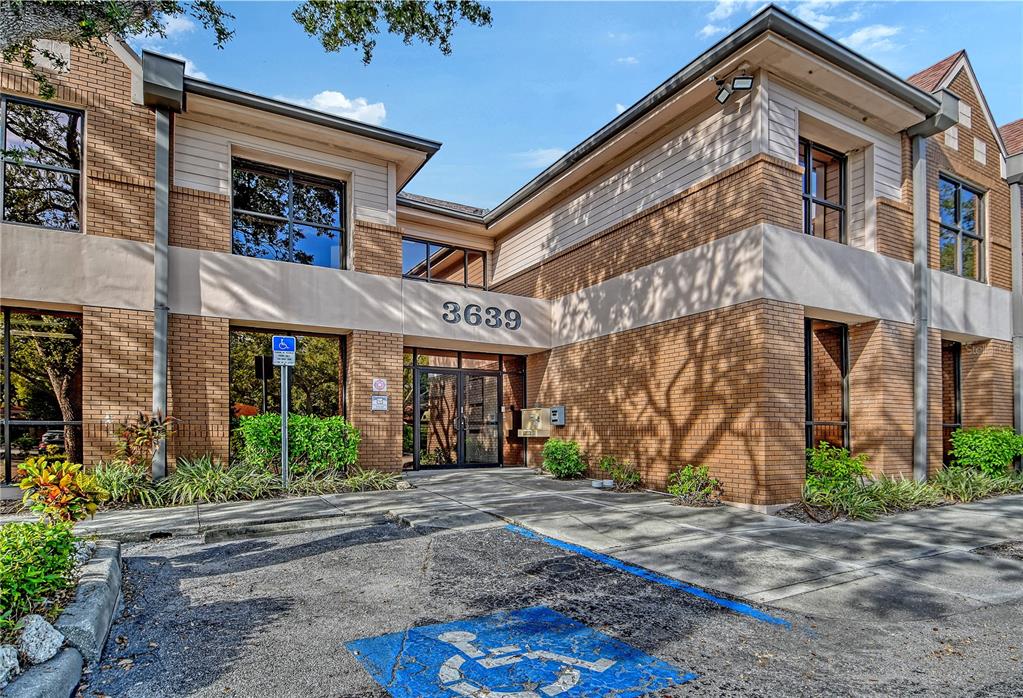 The exterior of a two-story brick office building features a handicap parking space and entrance — 3639 CORTEZ ROAD W UNIT 225, BRADENTON, FL