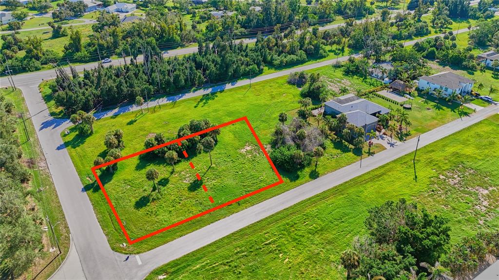 An aerial view shows a vacant, rectangular grass lot outlined in red next to a house — 141 POMPANO STREET, PLACIDA, FL